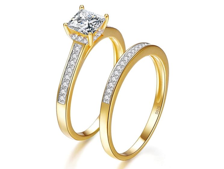2 gold engagement rings with a 925 marking inside the ring
