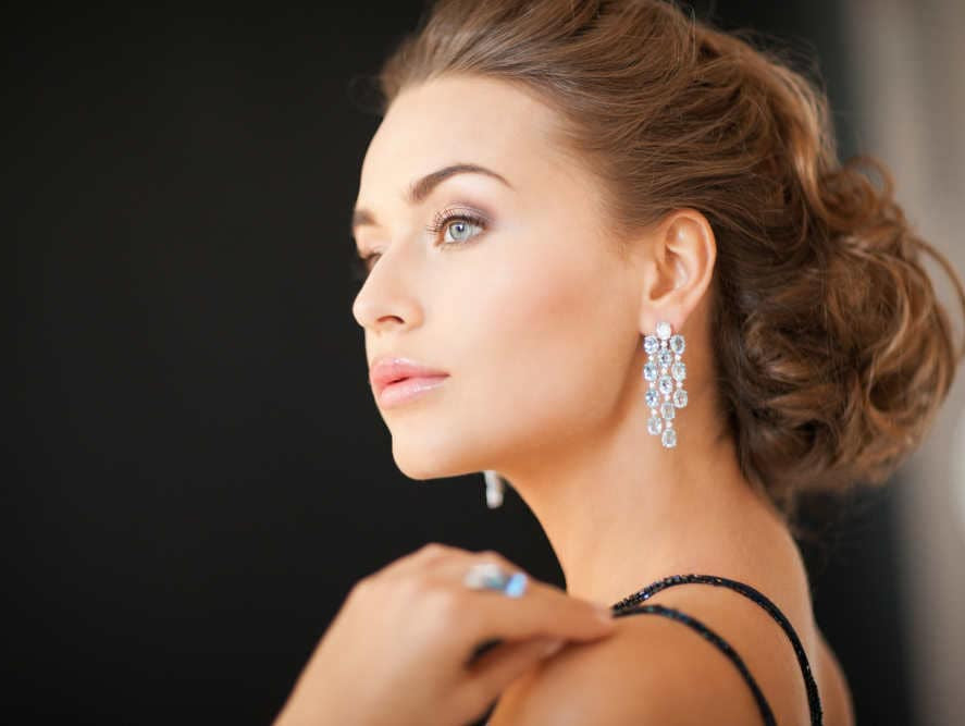 Image by SydaProductions via Shutterstock - woman wearing diamond earrings